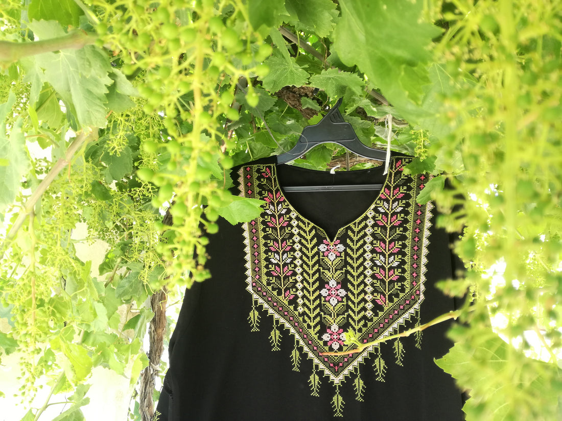Hand-embroidered Palestinian dress from Hebron with tatreez needlework, representing the regional embroidery traditions of Palestinian cities including Bethlehem