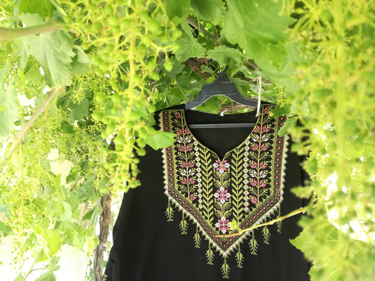 Hand-embroidered Palestinian dress from Hebron with tatreez needlework, representing the regional embroidery traditions of Palestinian cities including Bethlehem