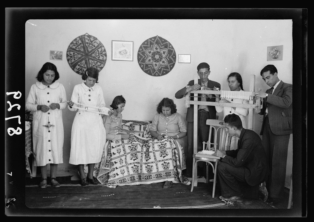 Young people at work in the Arab Women's Union of Ramallah work rooms, embroidering and weaving, mid-twentieth century