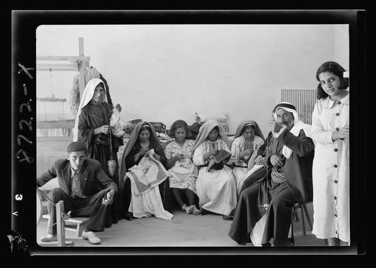 Members of the Arab Women's Union of Ramallah spinning wool and cross-stitch embroidering in the union's work rooms, mid-20th century