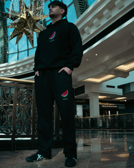 Watermelon Sweatpants in black — lifestyle view, watermelon print — FALASTIN