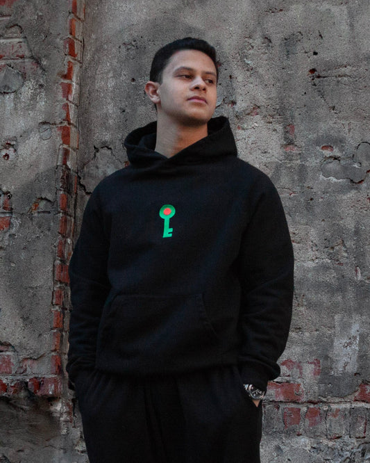 Key of Return Hoodie in beige — lifestyle close-up, desert setting — FALASTIN