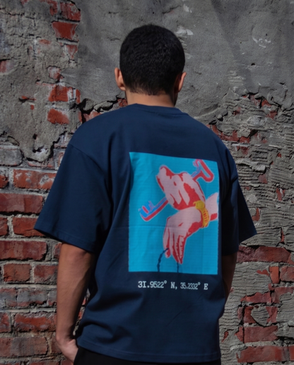 Back view of a model wearing the FALASTIN Key of Return T-Shirt in Blue