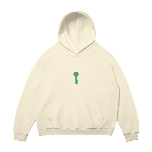 Mockup of front of Sand-colored hoodie featuring an embroidered green key logo with a red center, representing Palestinian heritage and the Key of Return.