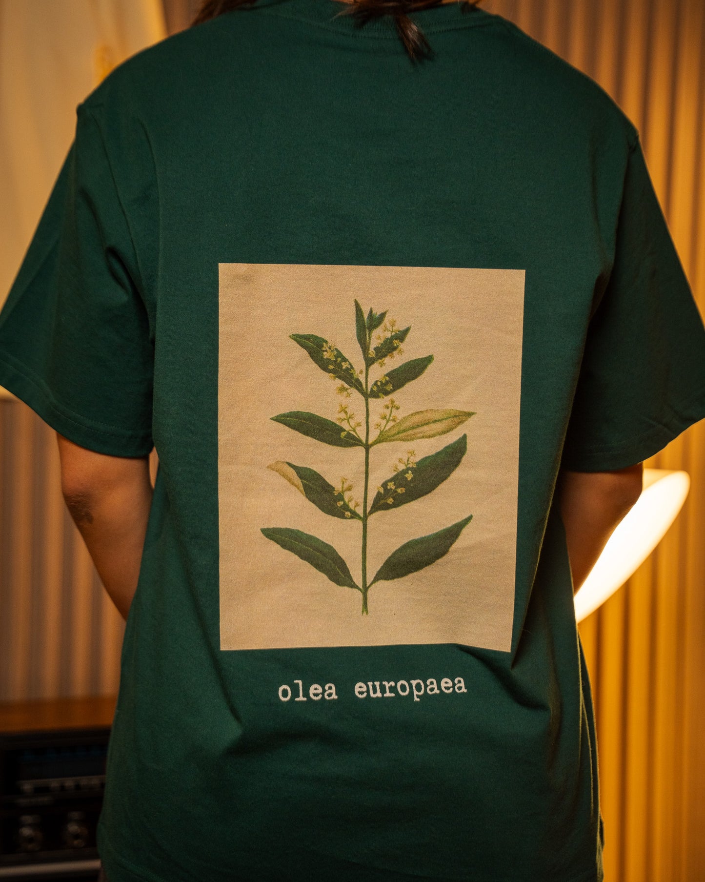 Olive Flower T-Shirt — model wearing Green, back view